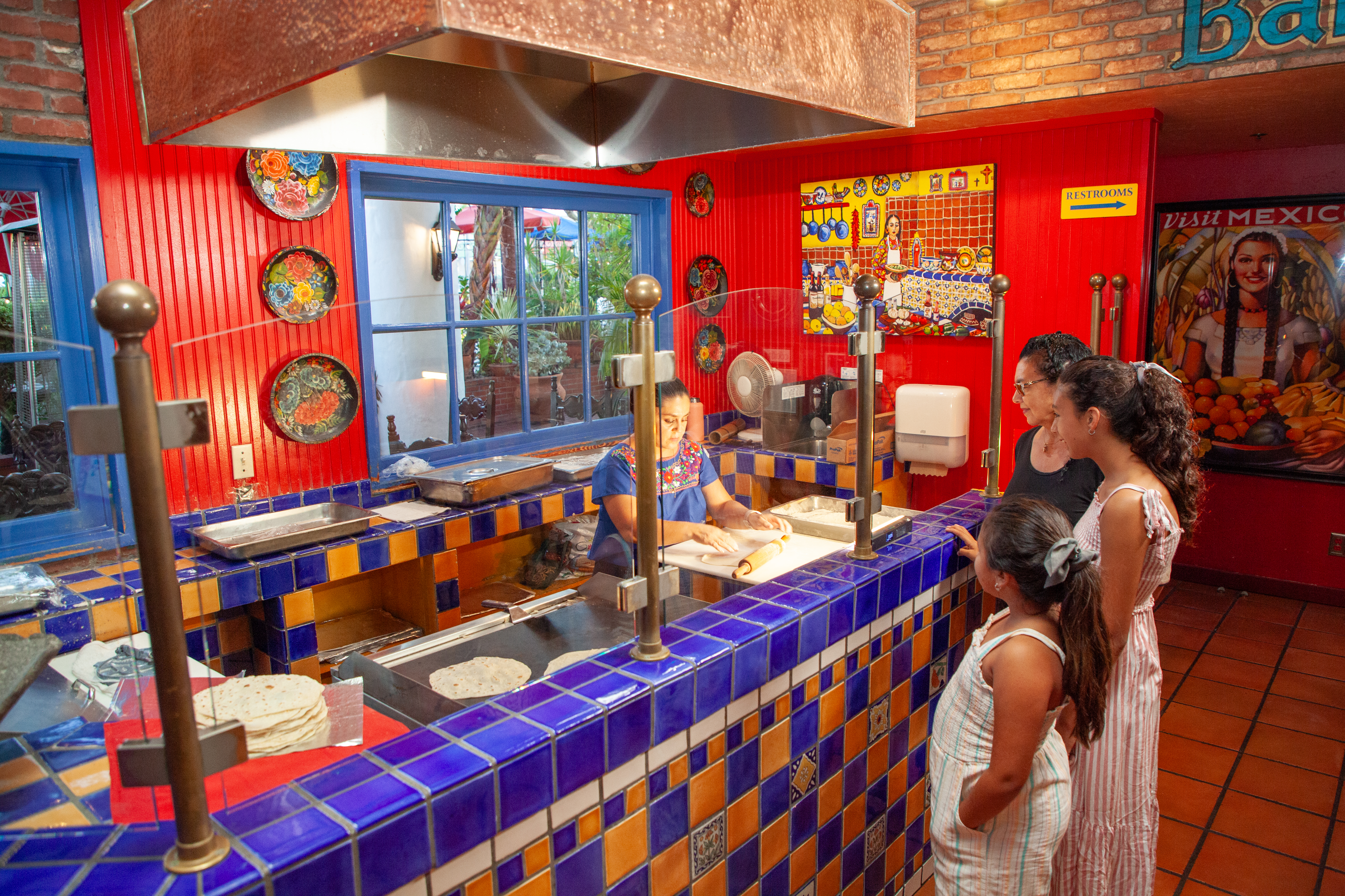 Corn tortilla being cooked on a hot griddle at Casa de Pico