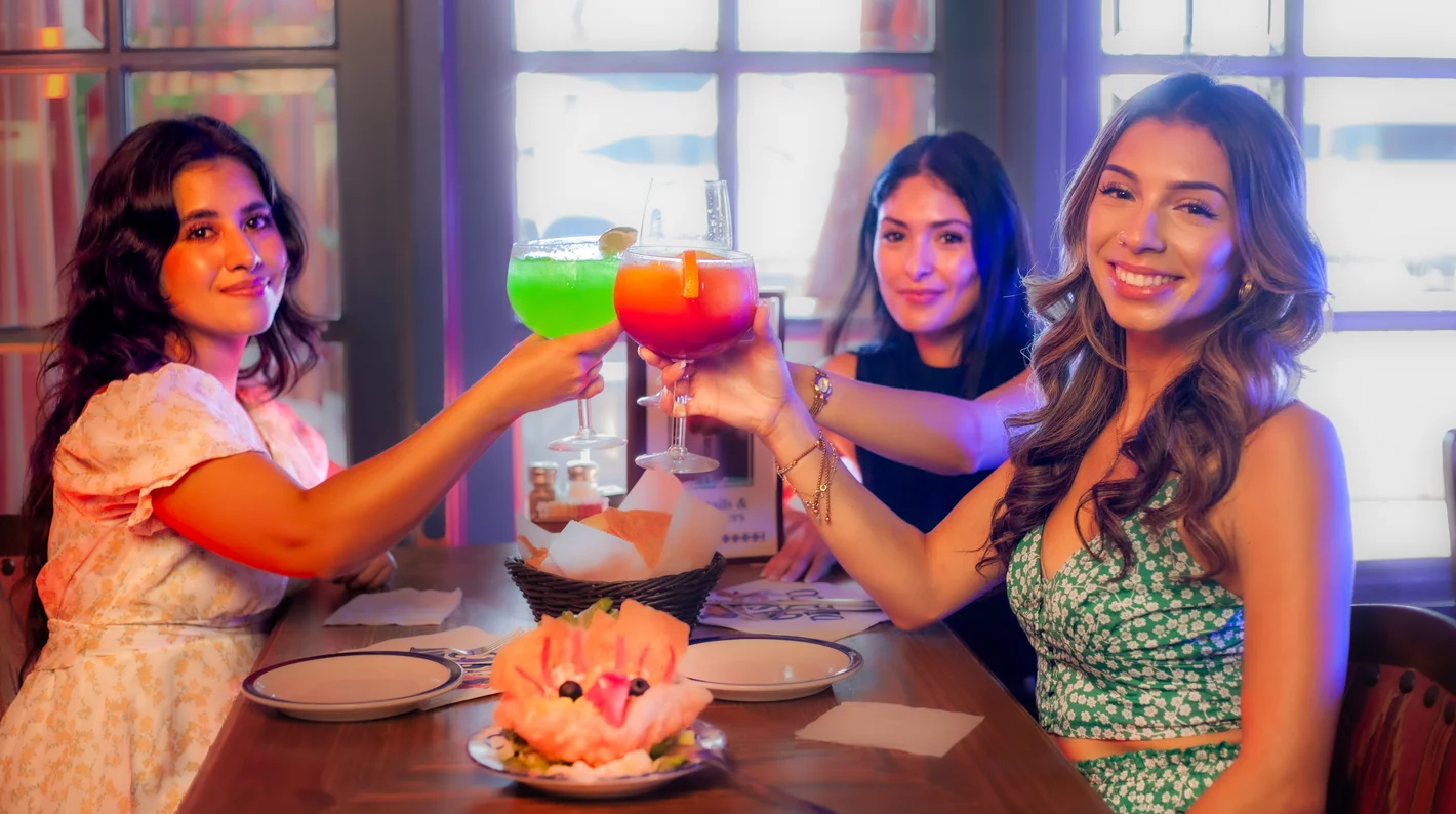 Guests toasting with colorful cocktails at the Casa de Pico cantina