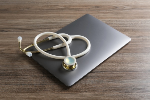 Patient preparing for a telehealth visit on a laptop at home in California