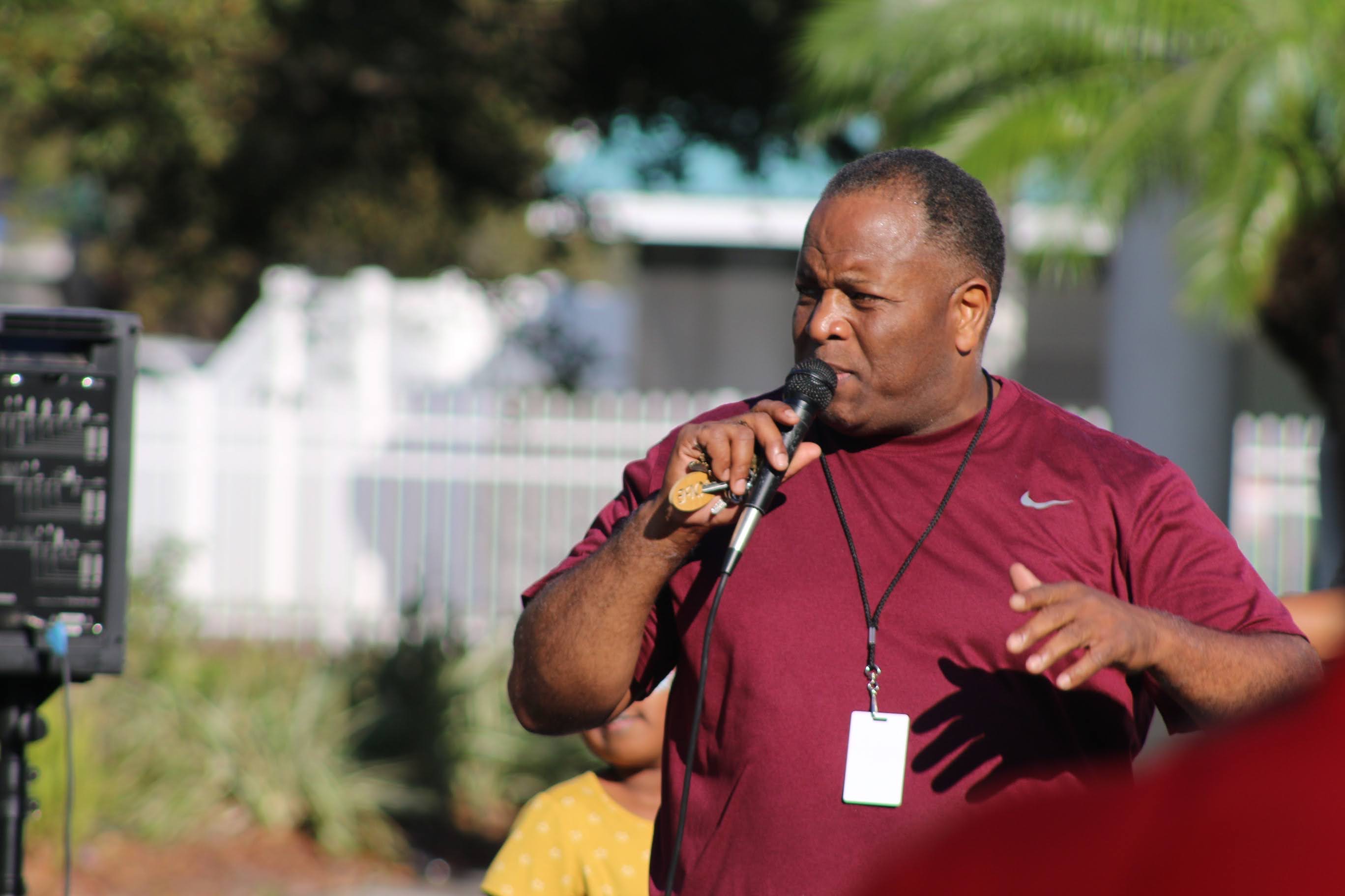 Alfred Johnson walking and engaging with a neighborhood