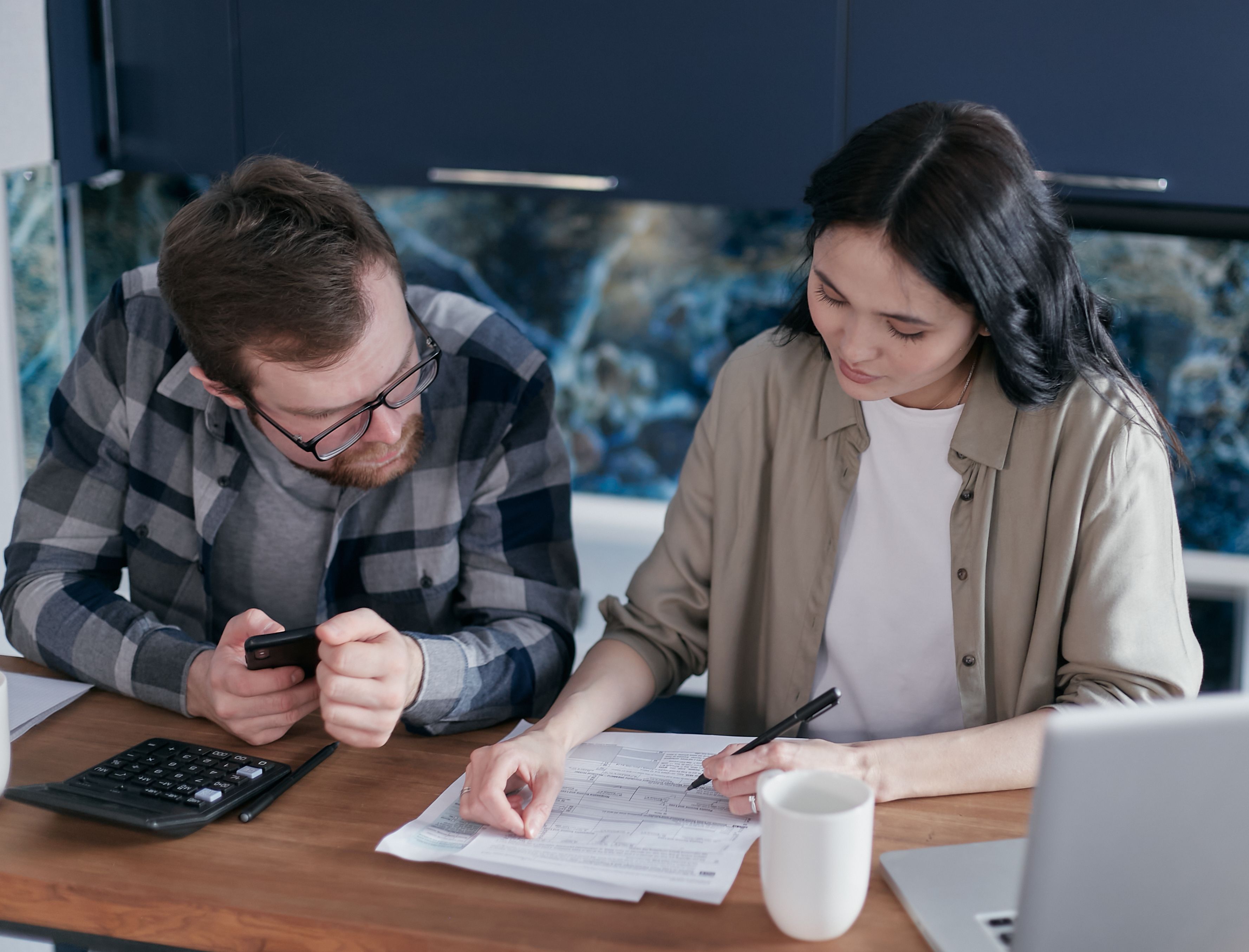 Advisor and couple reviewing whole life insurance cash value projections