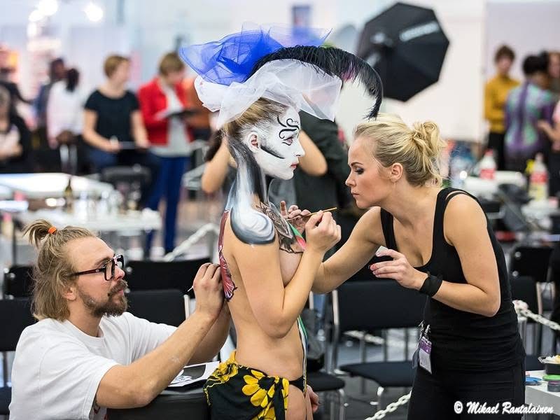Torsten and Kätlin Malm painting a model at a bodypainting competition early in their art journey