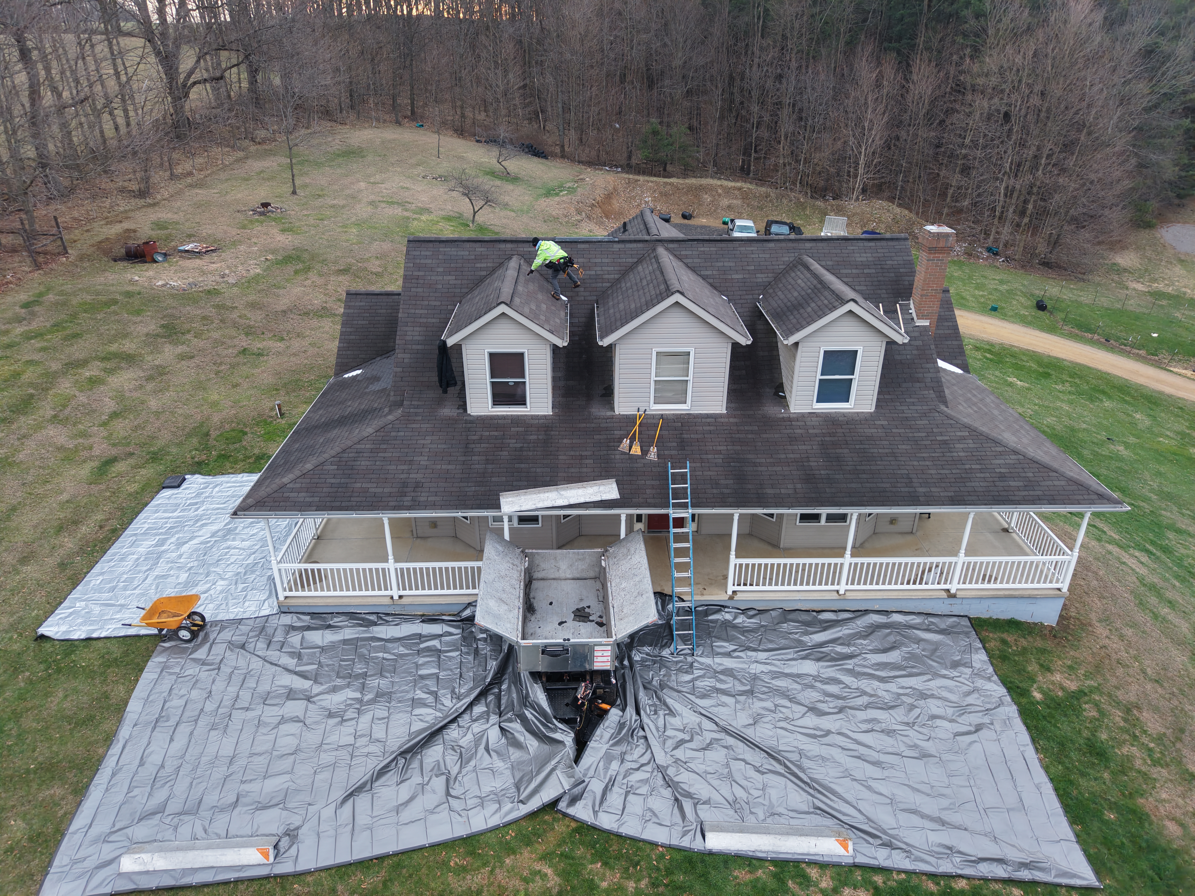 Weikles Roofing replacing a residential roof in Perrysville Ohio using an EQUIPTER to protect the yard and ensure a clean installation.
