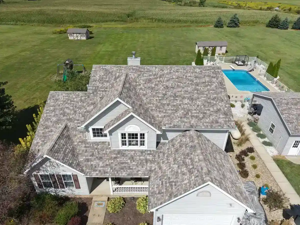 Aerial view of completed asphalt shingle roof on country home in Perrysville Ohio by Weikles Roofing