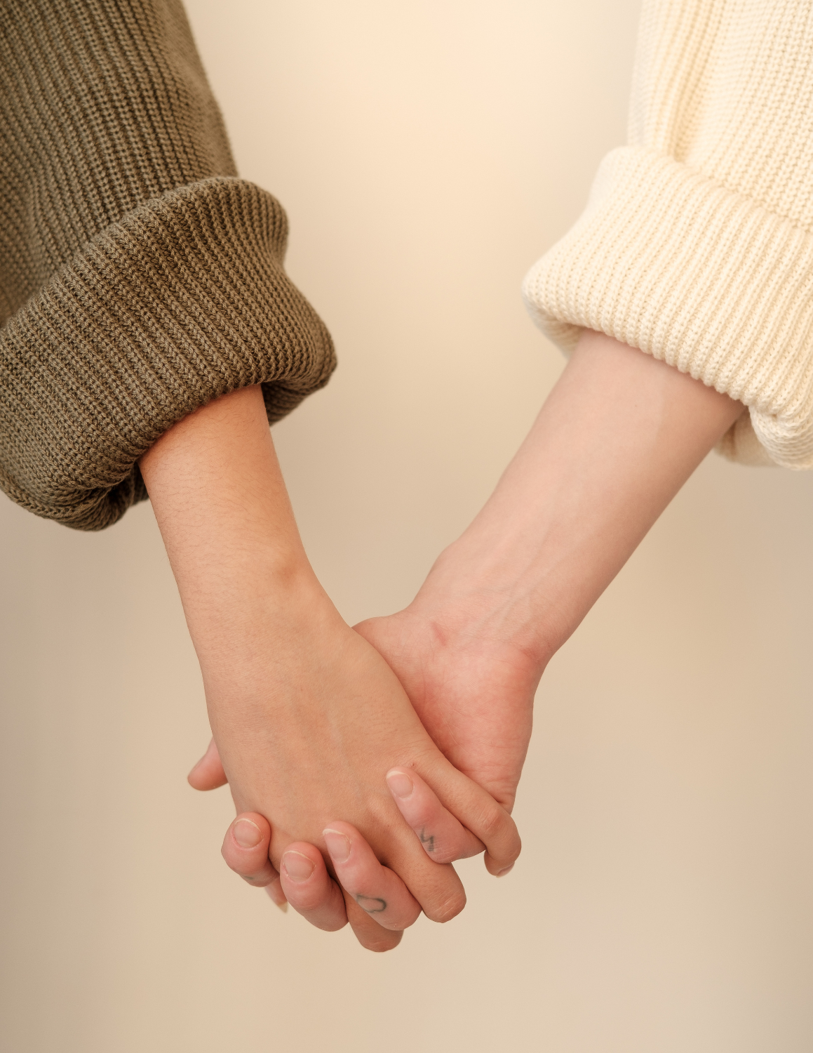 Two people holding hands, representing ongoing support