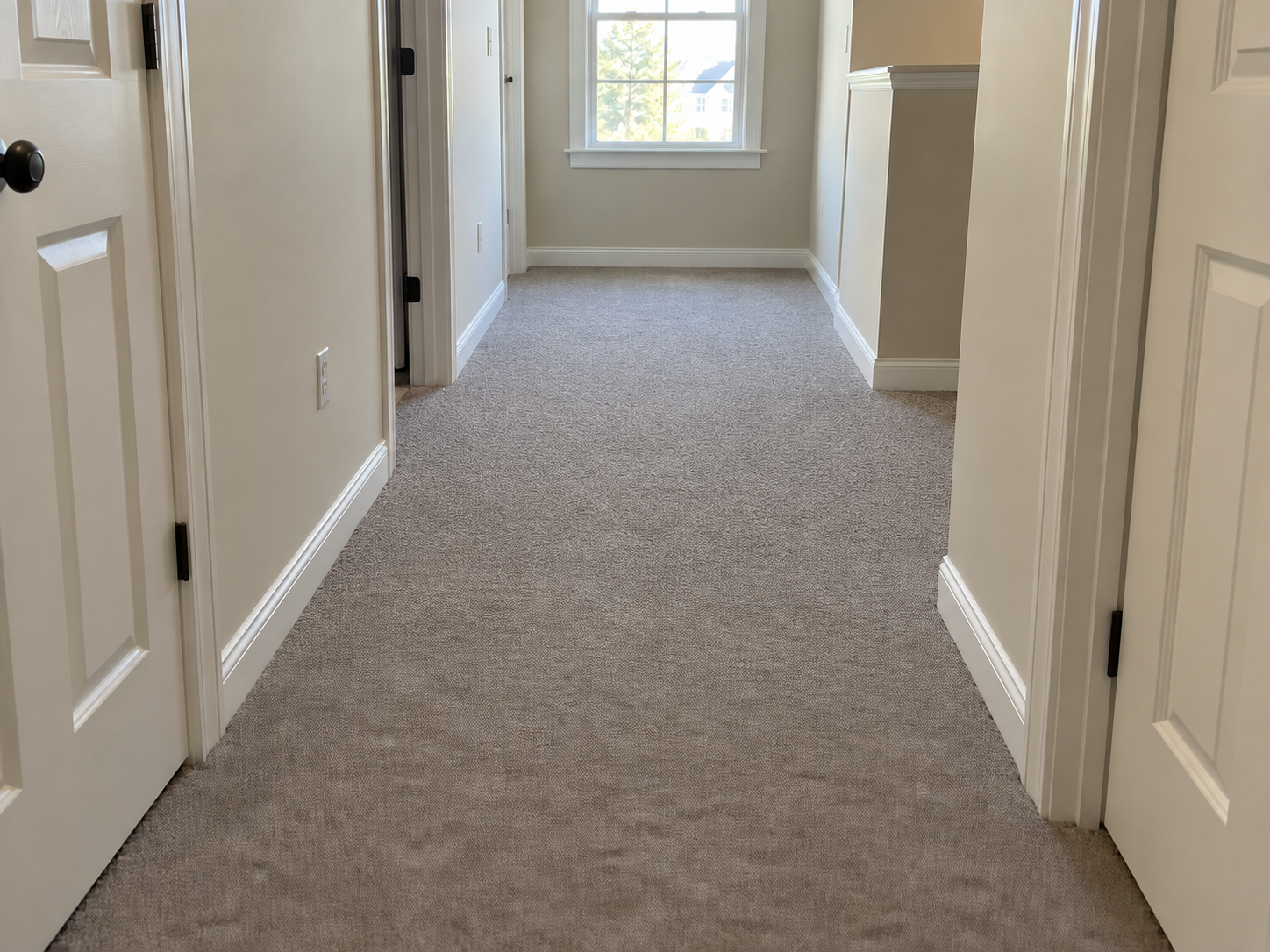 After: the same hallway carpet power-stretched completely flat from wall to wall
