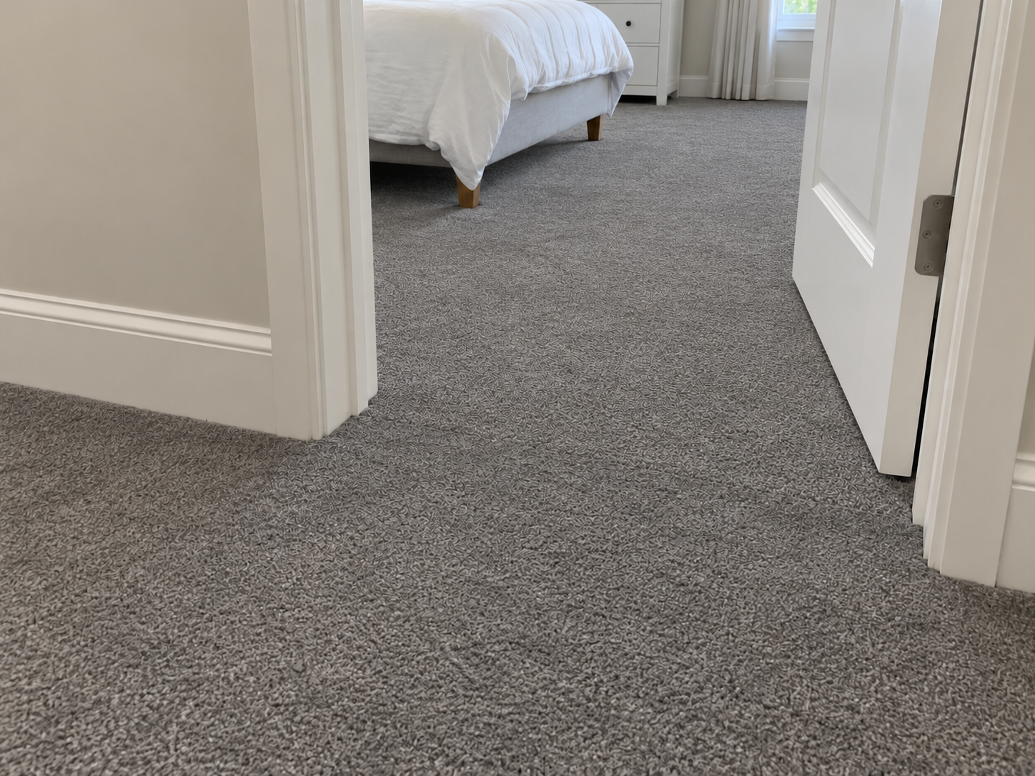 After: the same doorway with both carpet sections blended to one matching gray and no visible shade line