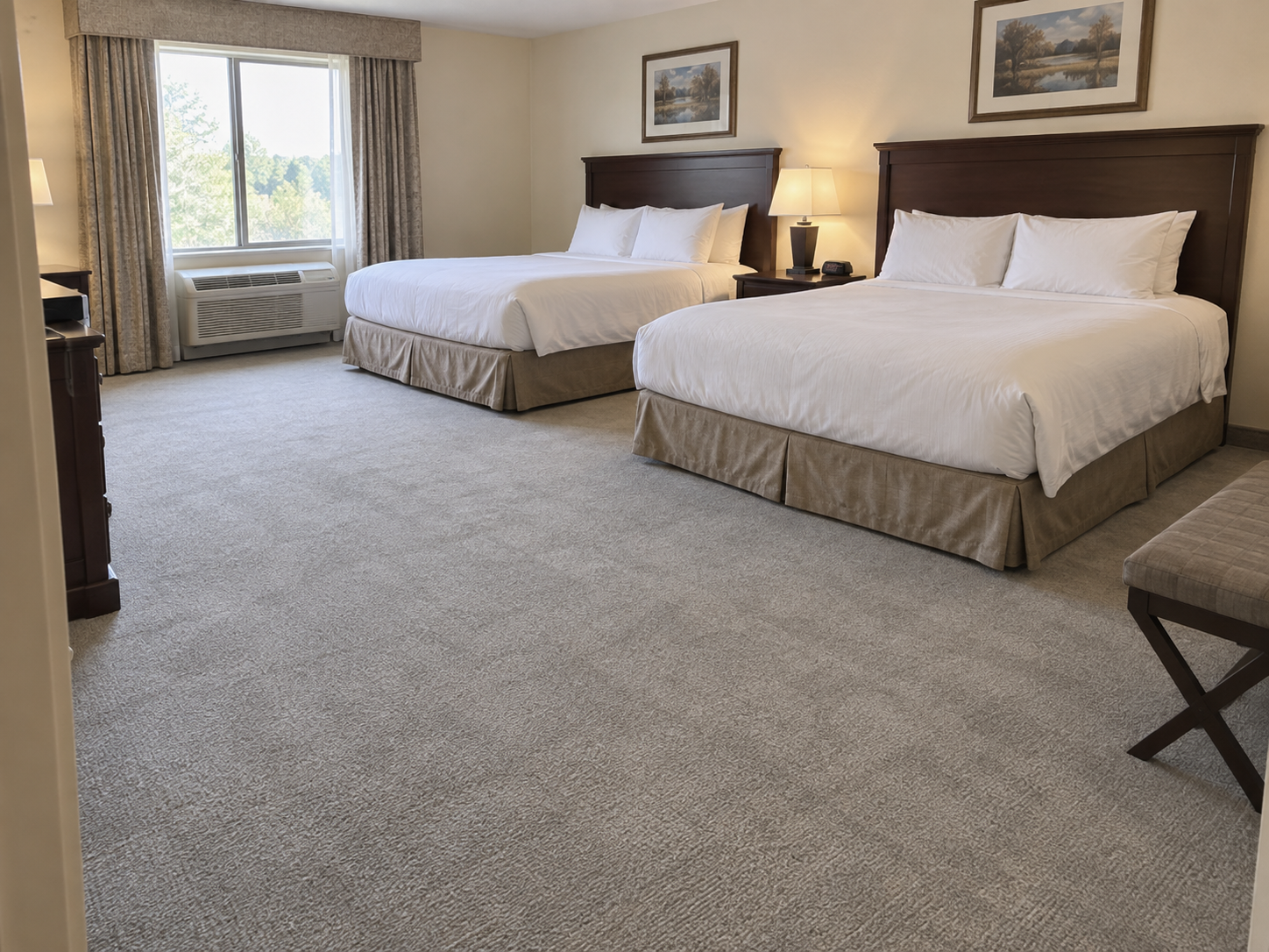 Before: hotel guest room with faded light gray wall-to-wall carpet