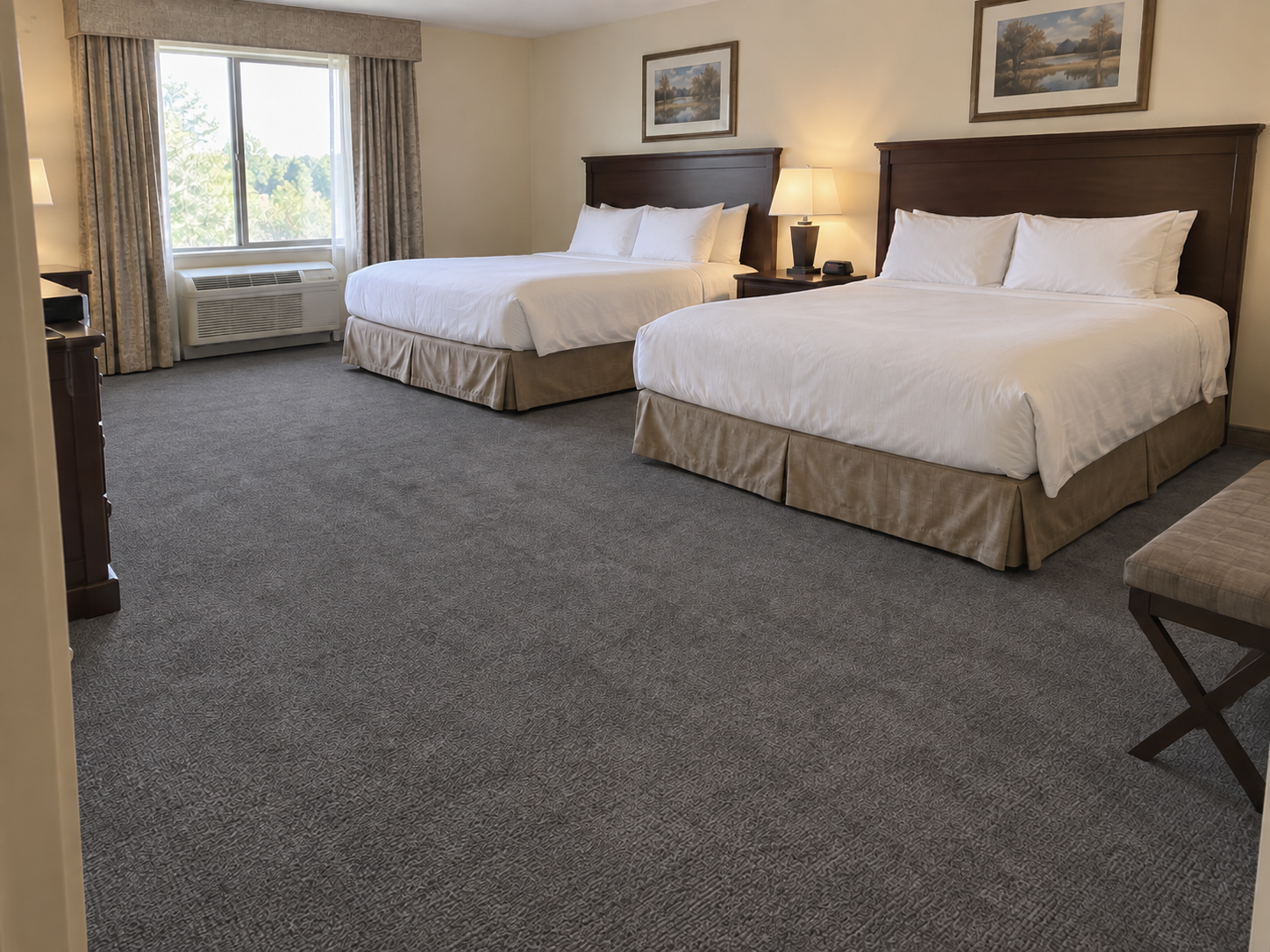 After: the same hotel room carpet dyed wall to wall in an even charcoal gray