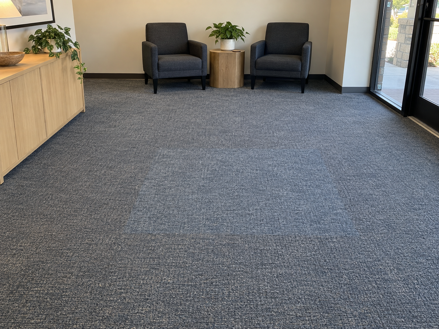 Before: office lobby carpet with a lighter rectangular faded zone in the middle of the floor