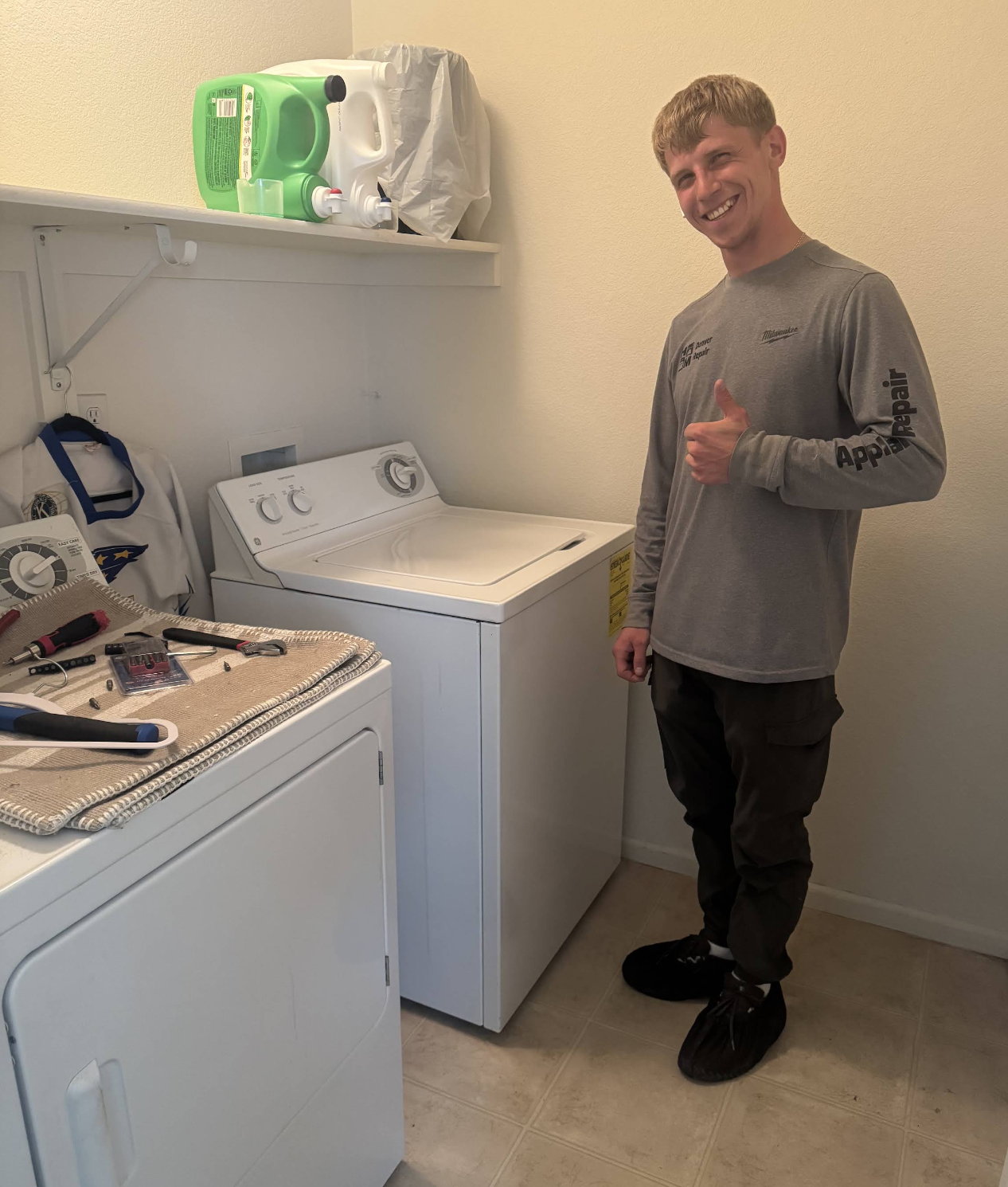 Gena giving a thumbs-up after a washer and dryer repair — Denver metro