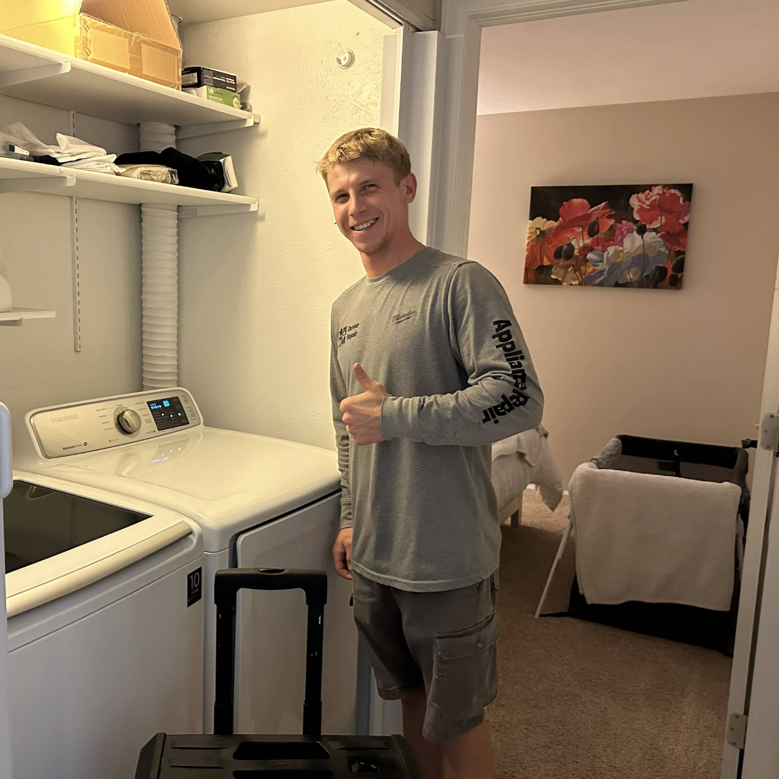Gena with two washing machines after completing service — Denver metro