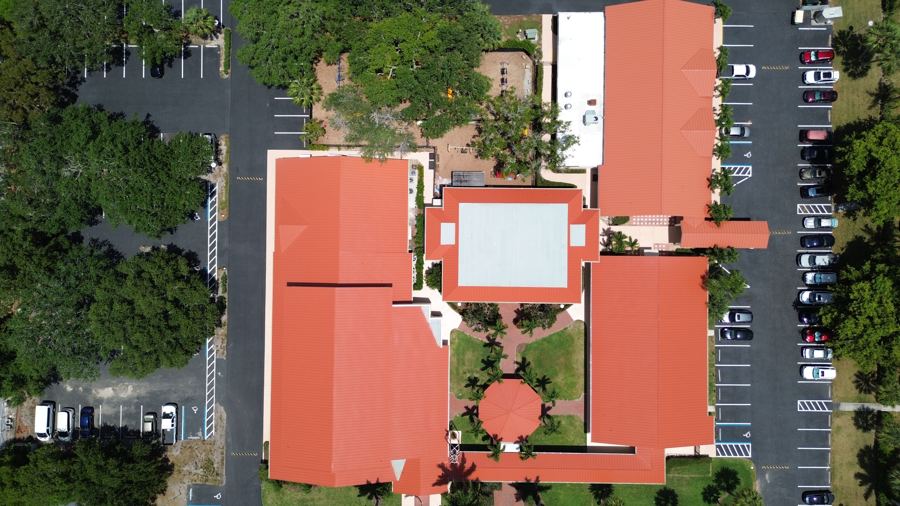 Aerial view of a commercial property with tile and low-slope roof sections