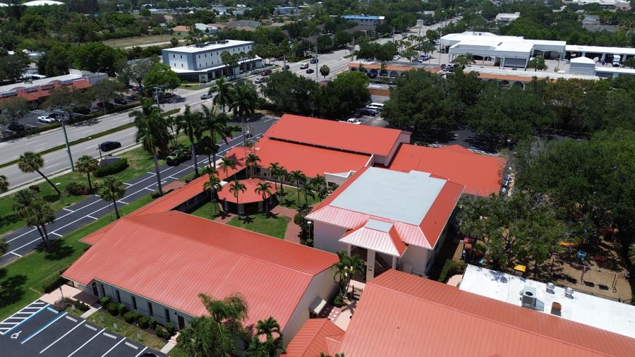 Aerial view of a multi-building property with tile roofs