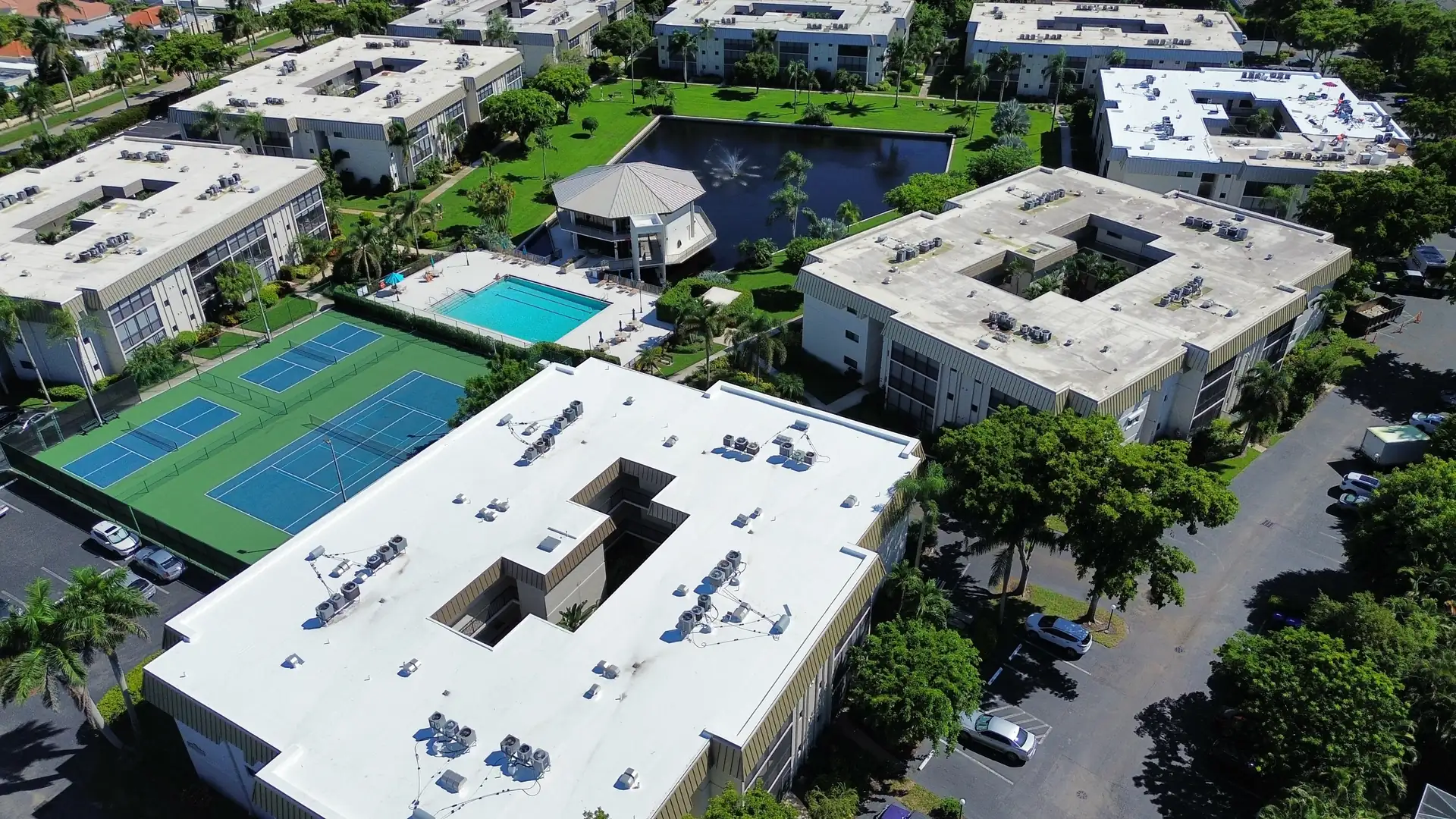 Wide aerial of a condominium community with white TPO roofs