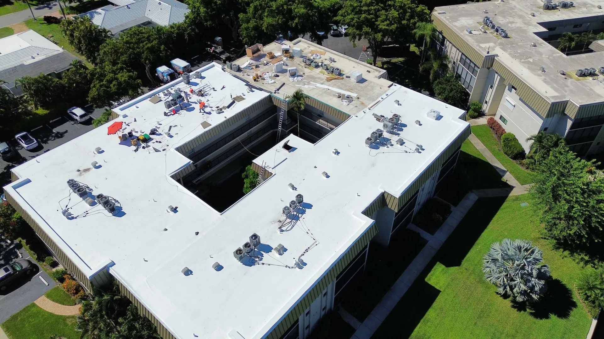 Aerial detail of a condominium wing roofed in white TPO membrane