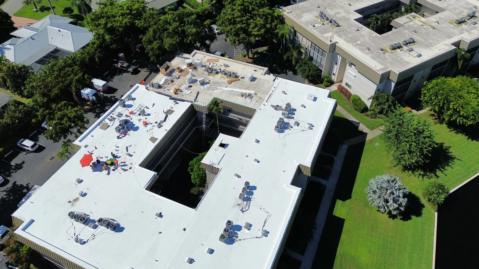 Close aerial of a white TPO roof with rooftop air conditioning units