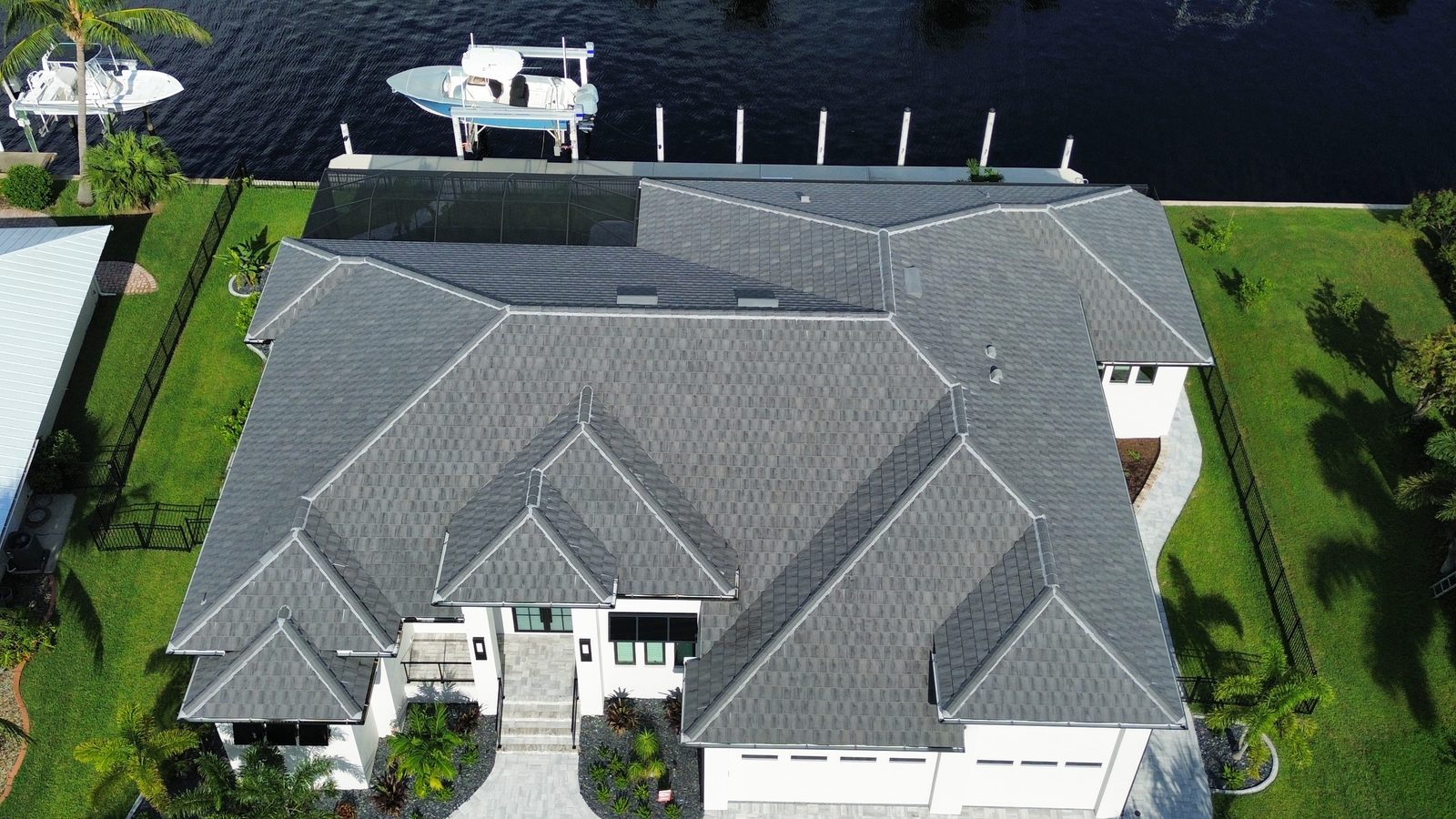 Aerial view of a gray flat tile roof on a Punta Gorda Isles canal home by Shea Roofing