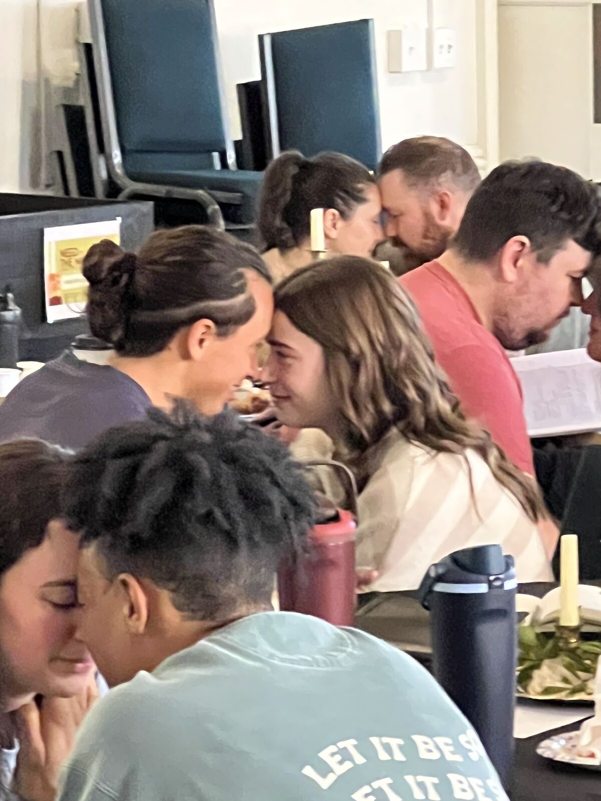 Couples leaning in, foreheads together, during a CO session
