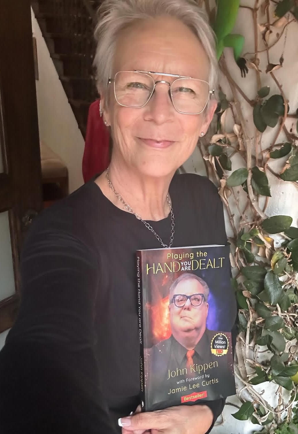 John Kippen holding his documentary book