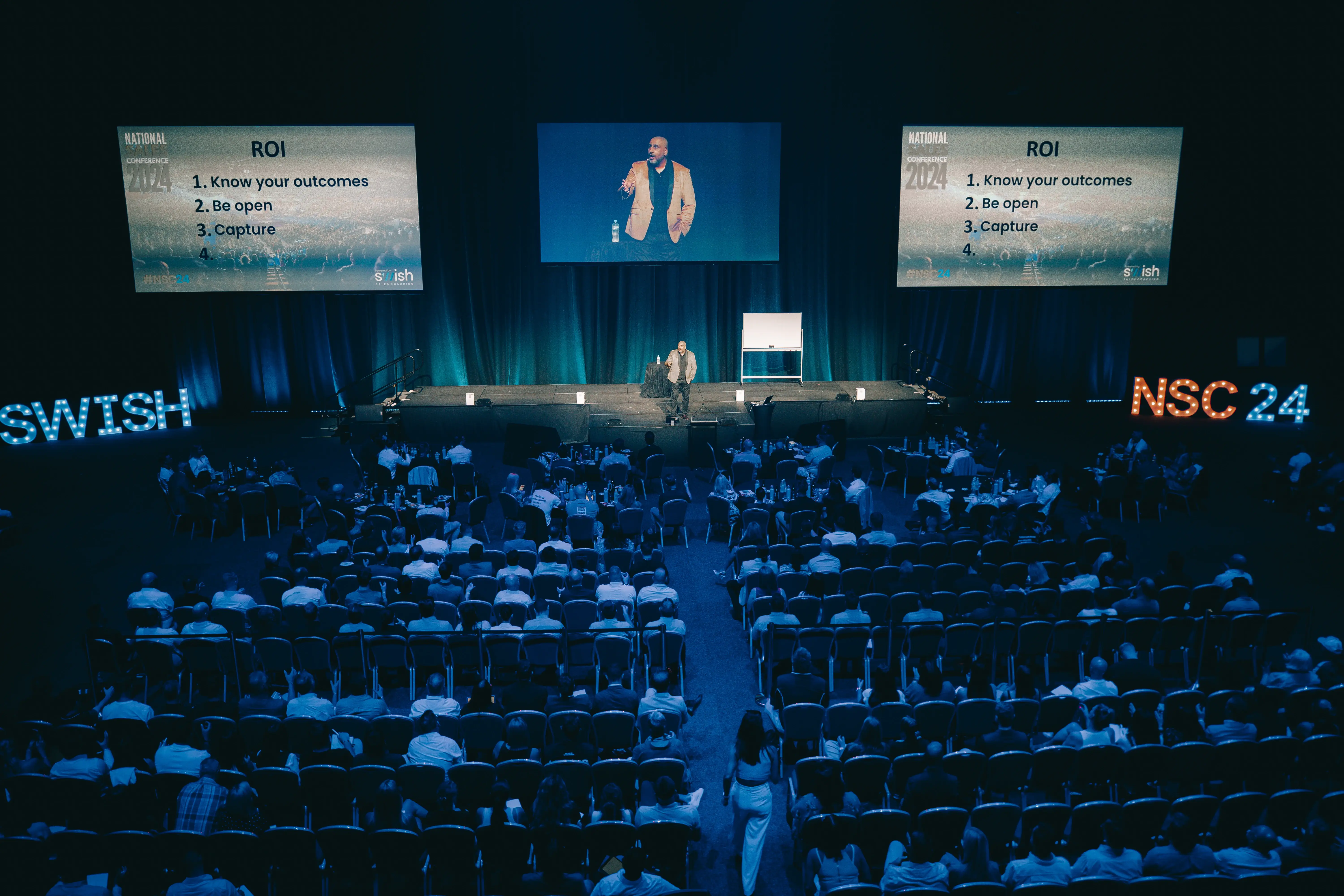 Premium conference room atmosphere with audience scale
