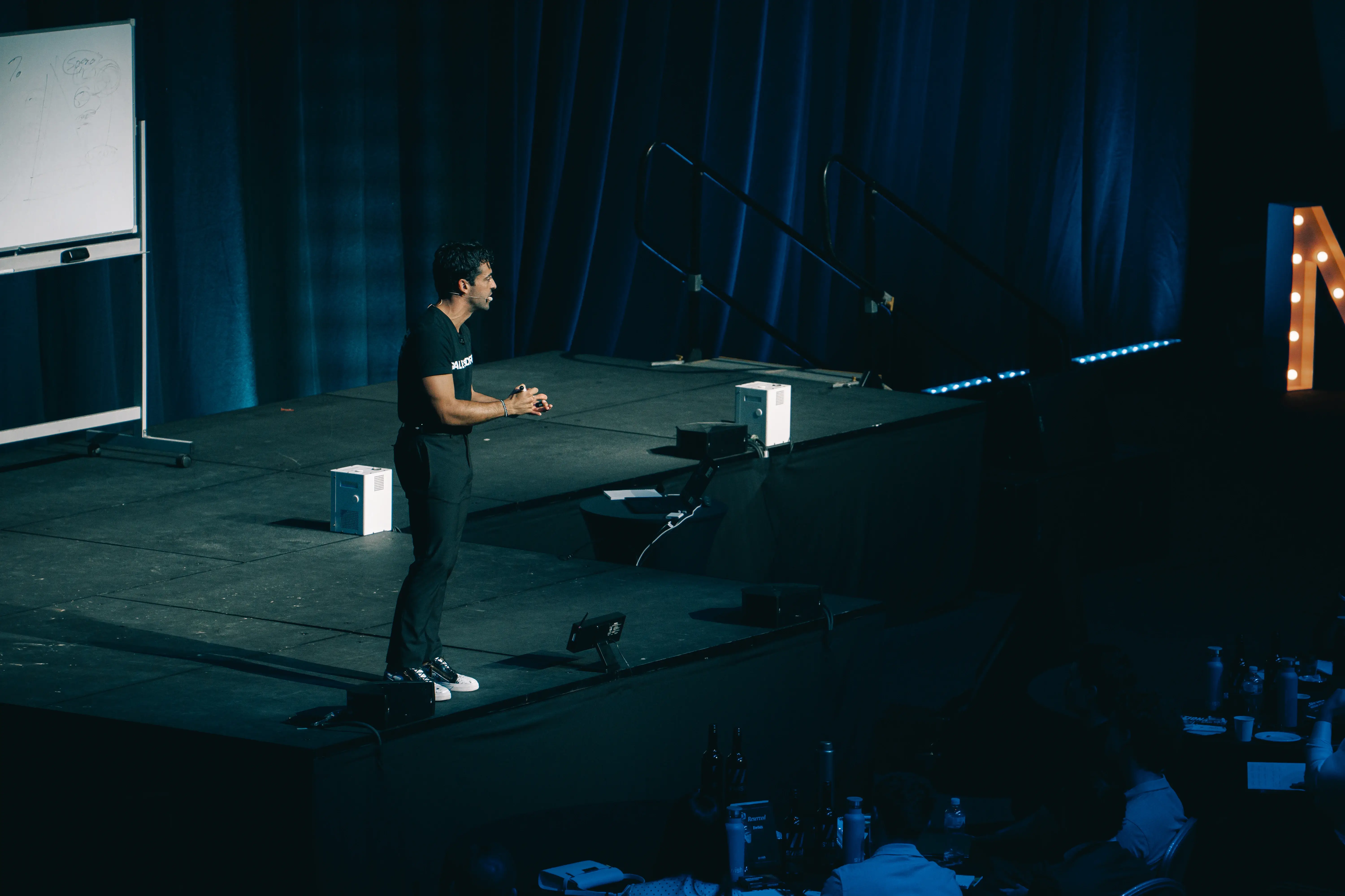 Premium stage production detail with a speaker on stage