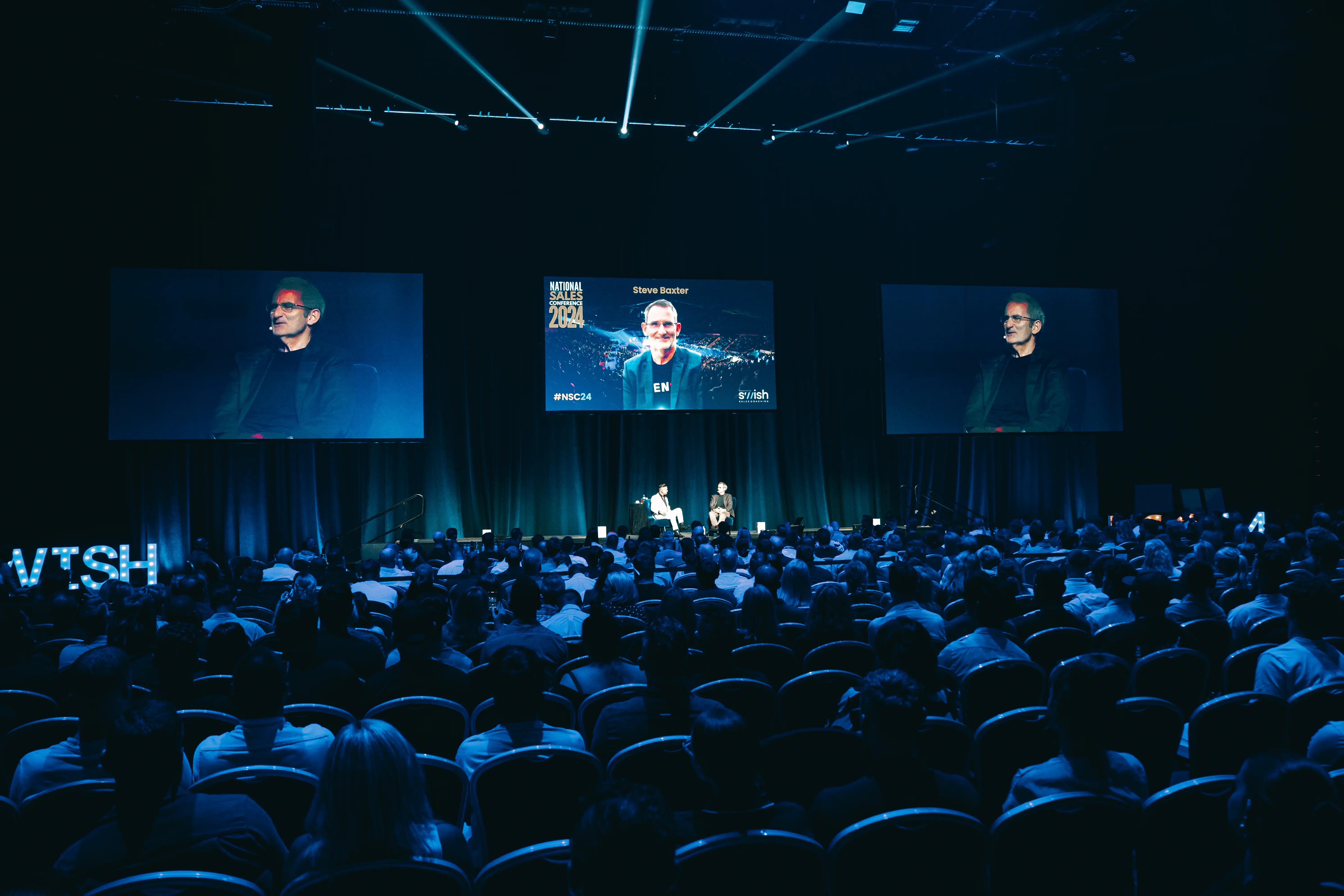 Large premium event room with wide production and audience scale