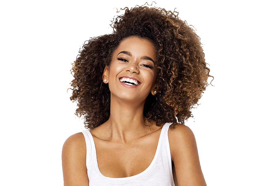 A Dominican woman with curly brown hair and a white tank top is laughing with a big open mouth smile.