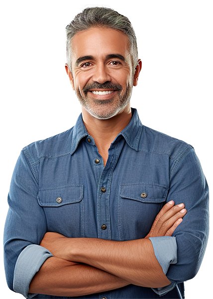 Ethnic man with salt and pepper hair and short beard in a blue shirt with sleeves rolled up and arms folded 