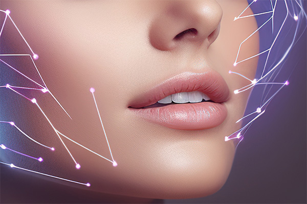 Tight close up shot of the lower part of a womens face with laser type geometric lines representing the biostimulation laser. She has her moth partially open to show her teeth and part of her nose