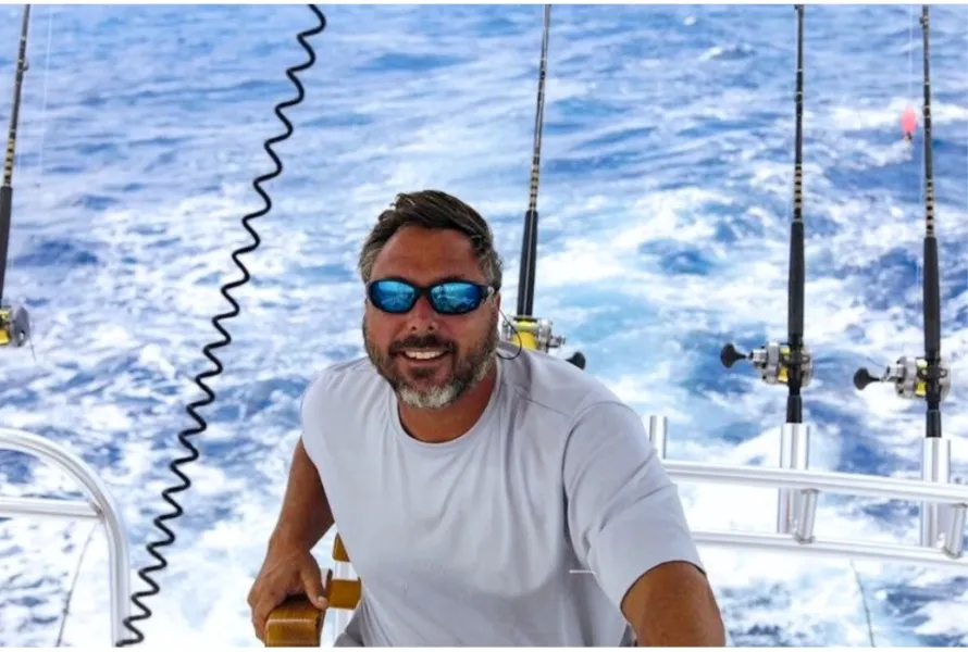 Captain on deck with trolling rods, RingMaster Charters—offshore fishing near Pompano Beach, FL.