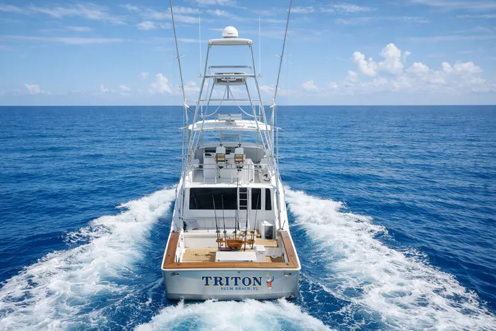 Captain on deck with trolling rods, RingMaster Charters—offshore fishing near Pompano Beach, FL.