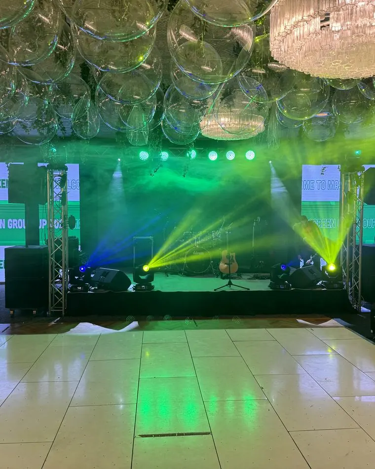 Corporate event stage with LED screens, PA system and beam lighting