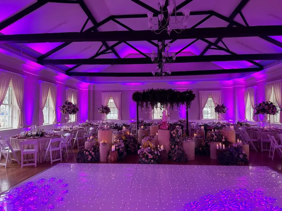 Wedding venue transformed with purple uplighting and LED dance floor