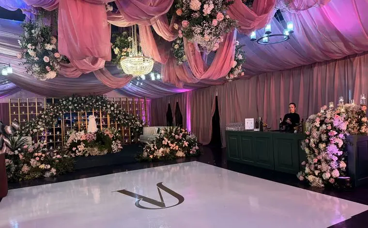 Reception space with ambient lighting and a clean DJ setup