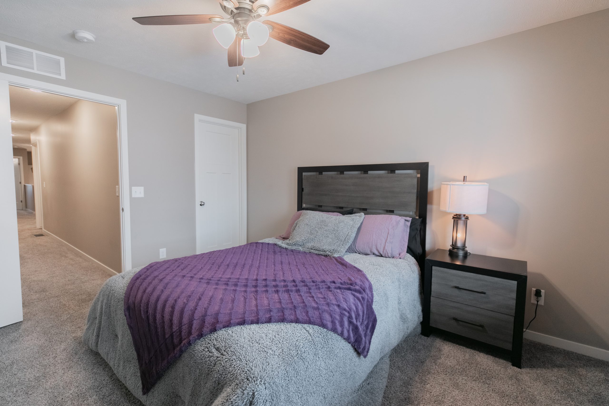 Bright bedroom with carpet and ceiling fan