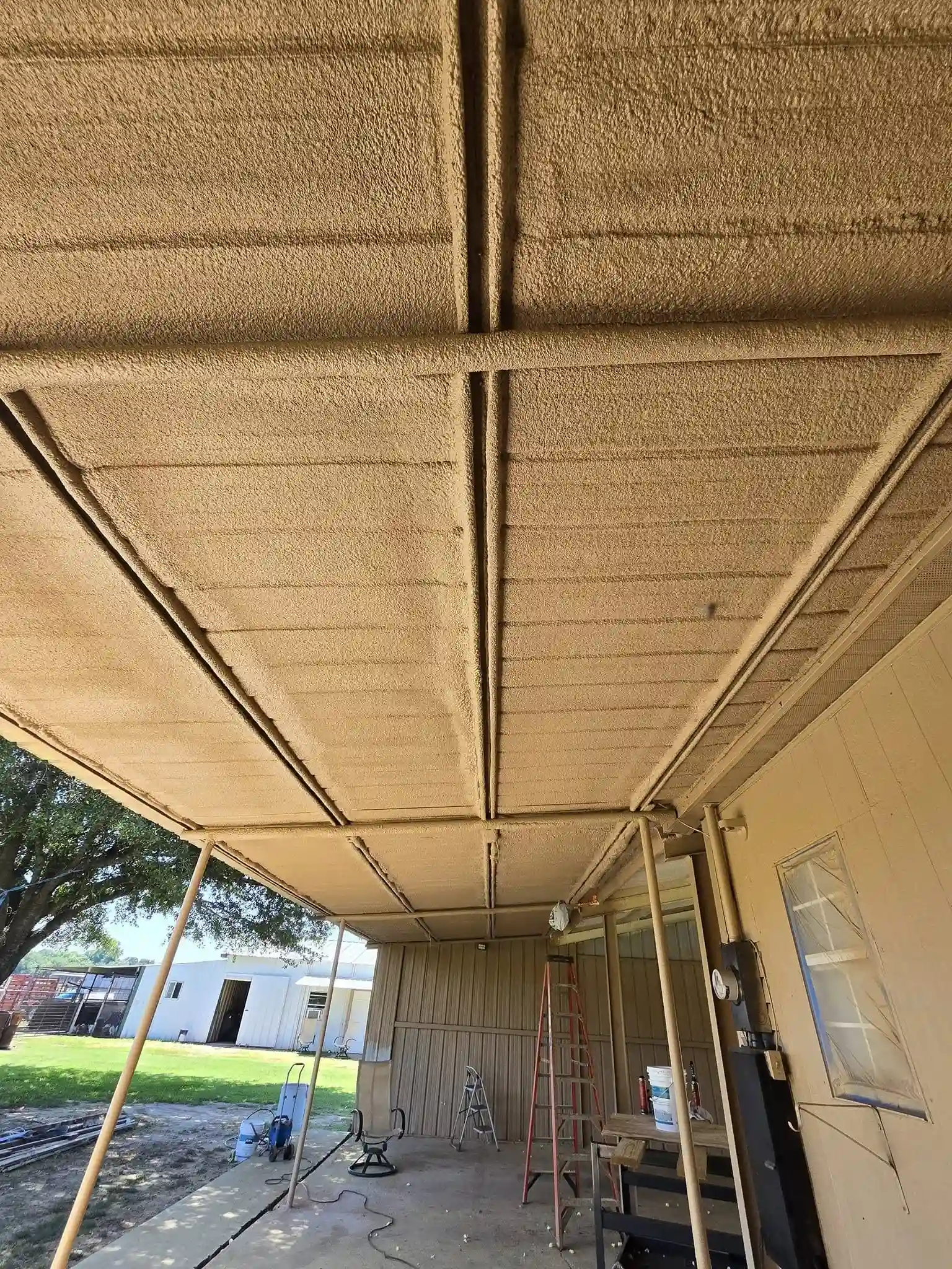 Closed-cell spray foam insulation applied to metal patio ceiling by 903 Spray Foam in Sulphur Springs, TX