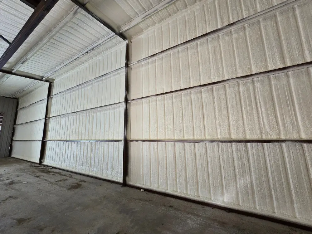 Closed-cell spray foam applied to metal garage walls for moisture resistance by 903 Spray Foam in Sumner, TX
