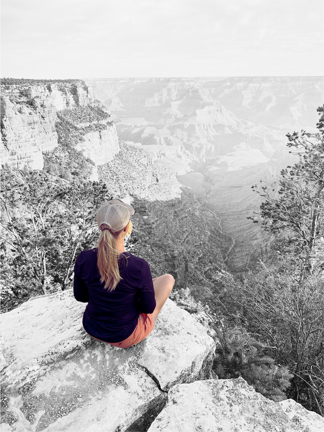 Tyffany sitting on a rock overlooking the Grand Canyon