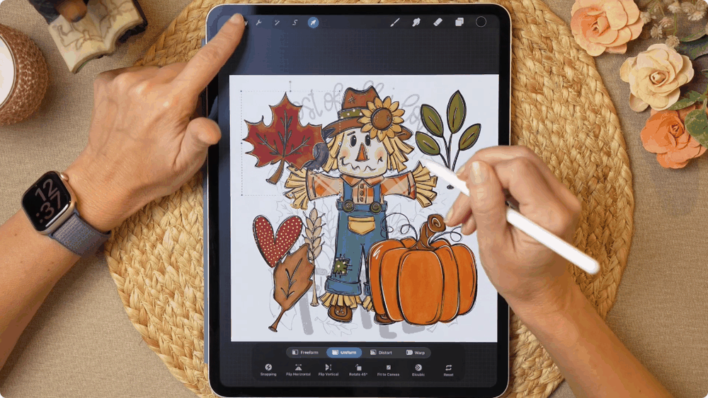 The finished scarecrow design with pumpkin and leaves in Procreate