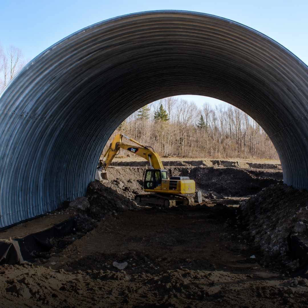 Large corrugated steel culvert installation during the Arch Project