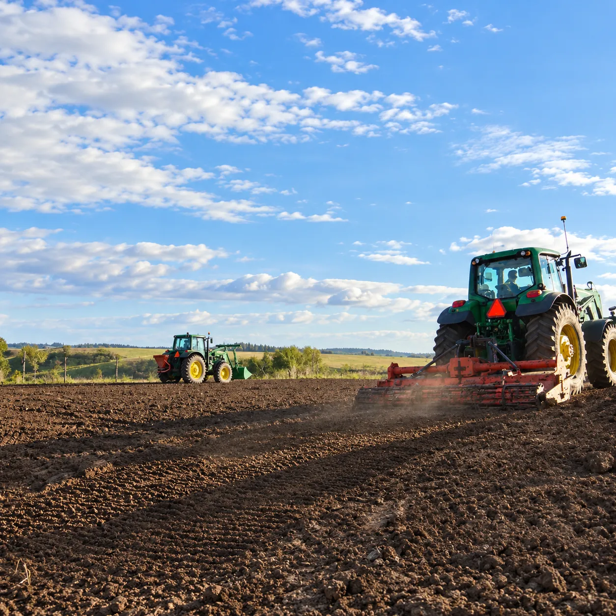 Tractor performing soil preparation for site reclamation
