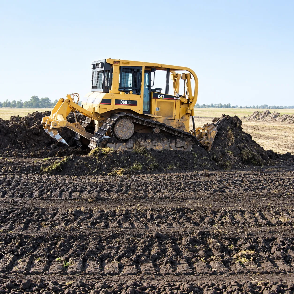 Crawler dozer grading land during reclamation work