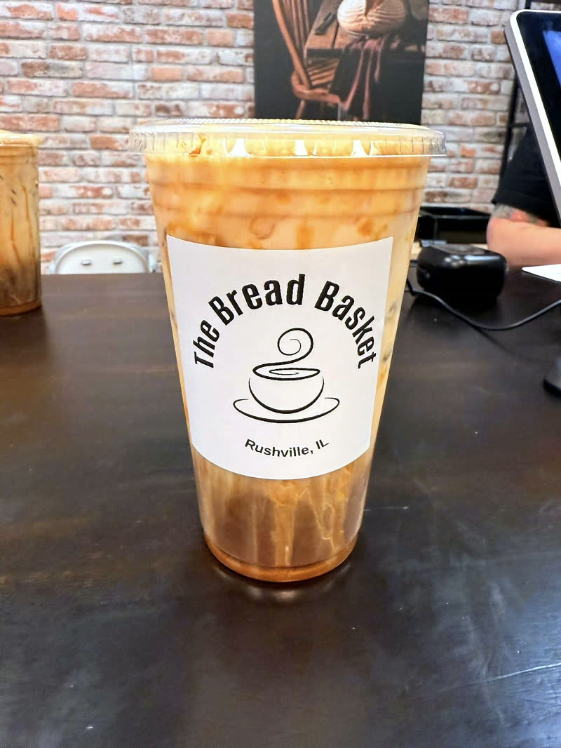 Iced drink in a Bread Basket cup at the counter.