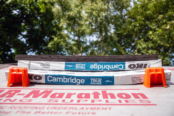BMF Roofing Solutions shingle anchor holding a pile of shingles
