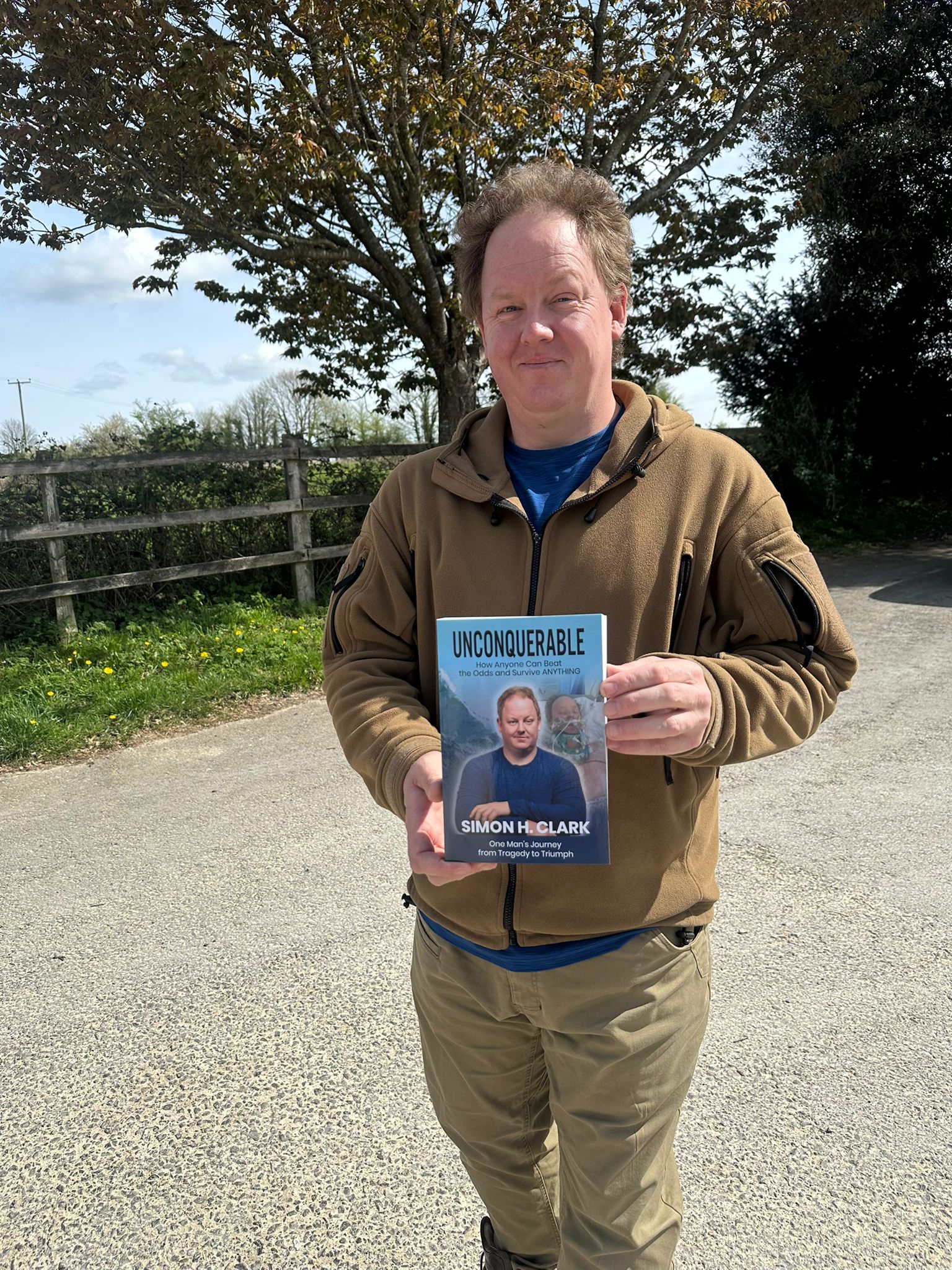 Simon Clark holding his book Unconquerable Simon Clark holding his book Unconquerable