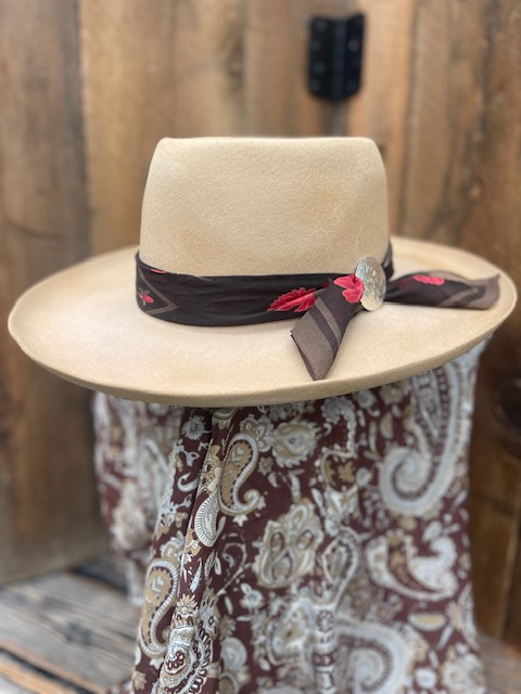 Cream felt hat with a paisley scarf hatband, studio-style shot