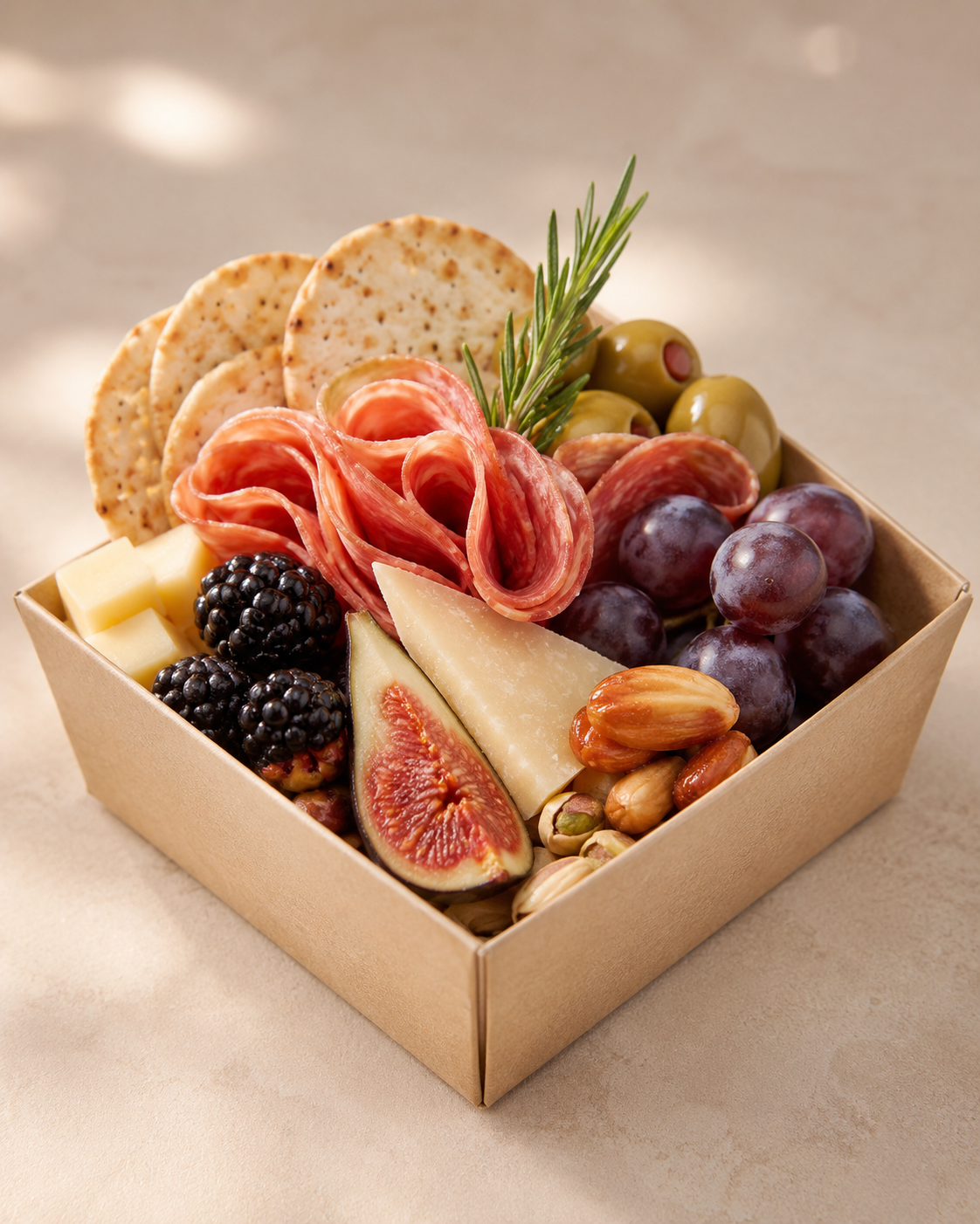 Premium individual charcuterie box with artisan cheeses, cured meats, fruit, crackers, olives and nuts