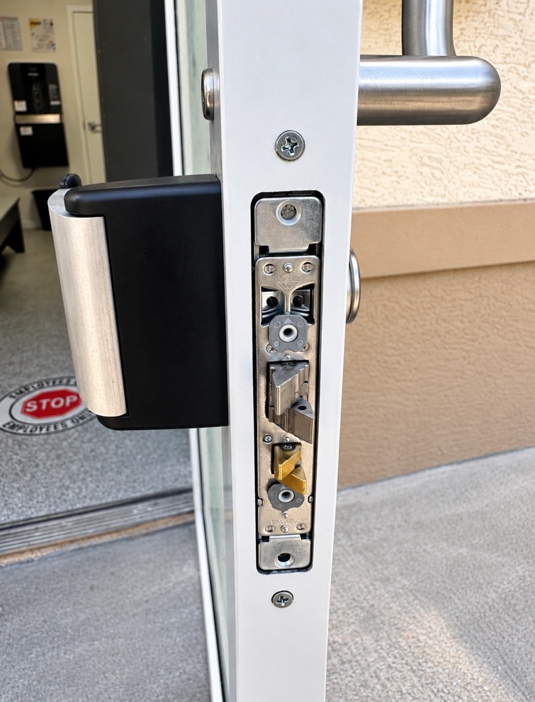 V Power Solutions technician installing an automatic door operator and hardware