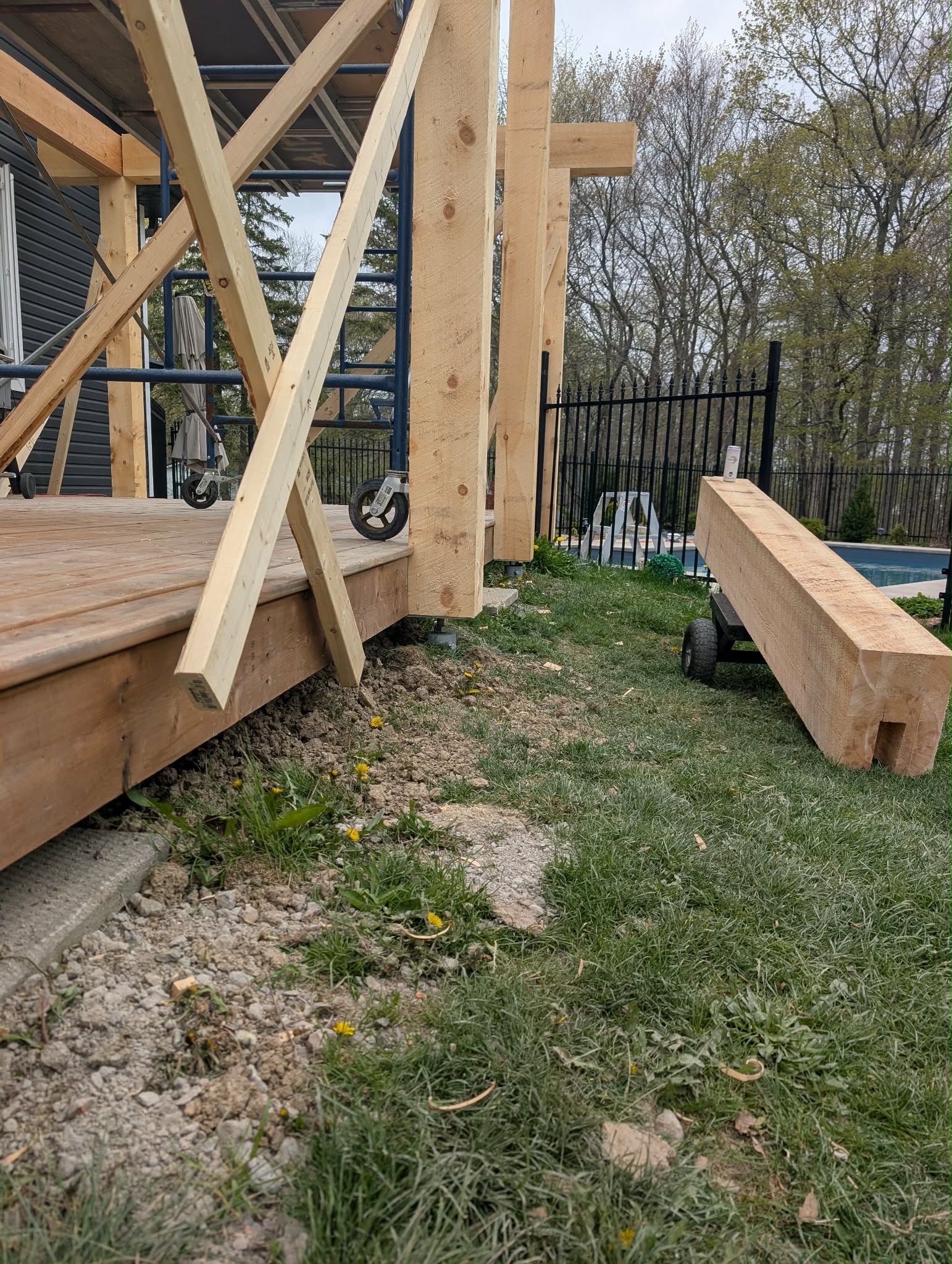 Timber frame covered deck supported by Postech Hamilton screw pile foundations in Binbrook Ontario